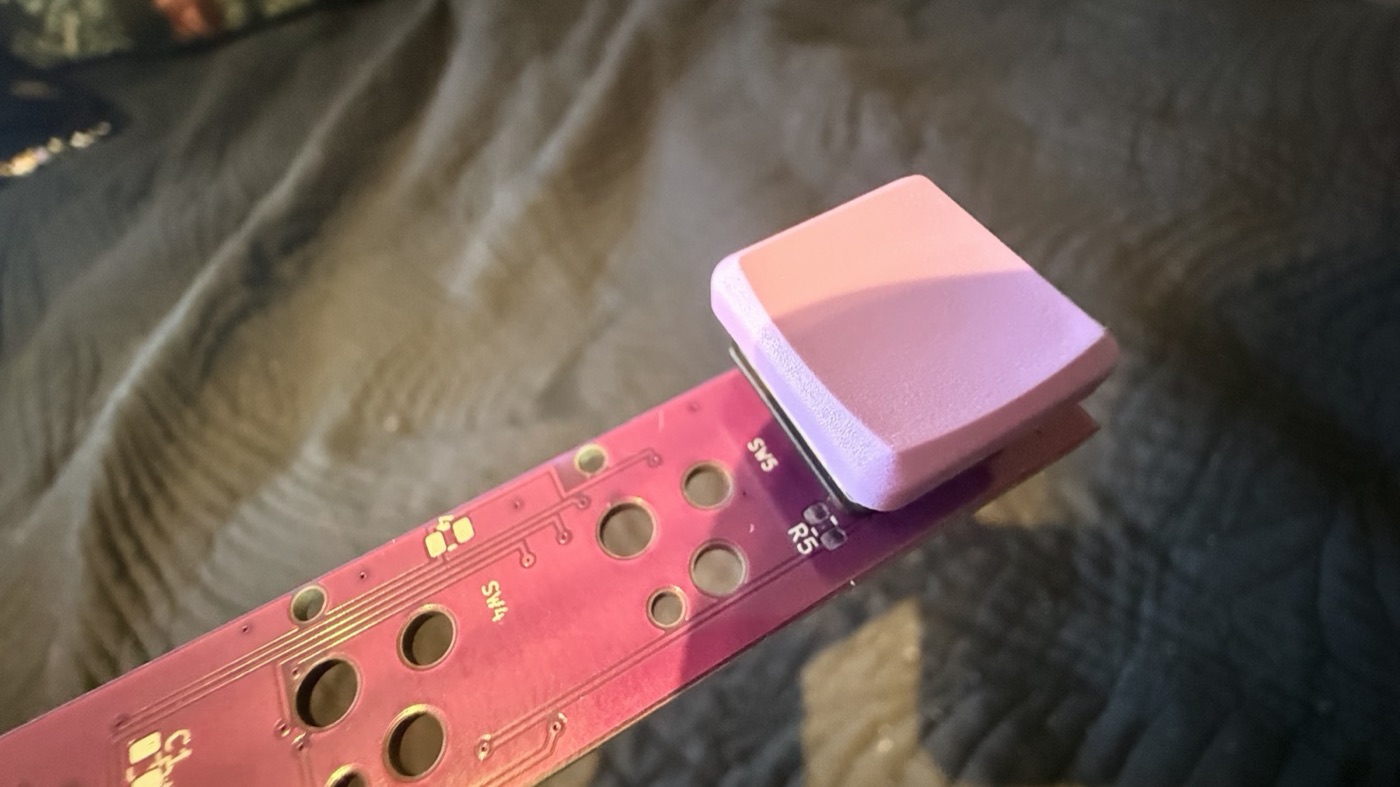 A bare purple key module board with one switch and keycap in the SW5 position